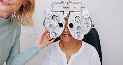 Buy stock photo Doctor, optometry and woman on phoropter for eye care, consultation and hands in clinic for health exam. Ophthalmologist, test and patient on machine for vision check, wellness or eyesight correction