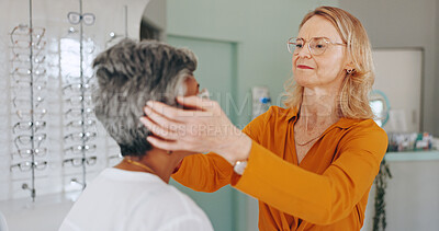 Buy stock photo Women, optometrist and patient at clinic for glasses, eye care and test lens for healthy vision. Mature doctor, people and assessment with spectacles, exam or wellness for sight with fitting at store