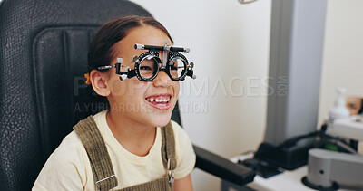 Buy stock photo Trial frame, smile or girl in eye test at optometry clinic for eyewear, retina health or sight wellness. Vision exam, excited or happy child in assessment for optical lenses, frames or spectacles
