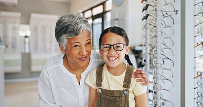 Buy stock photo Child portrait, optometrist and choice of frame at clinic, prescription glasses and helping client. Woman, optical store and specialist consulting on lens for girl, excited kid and care at eye exam