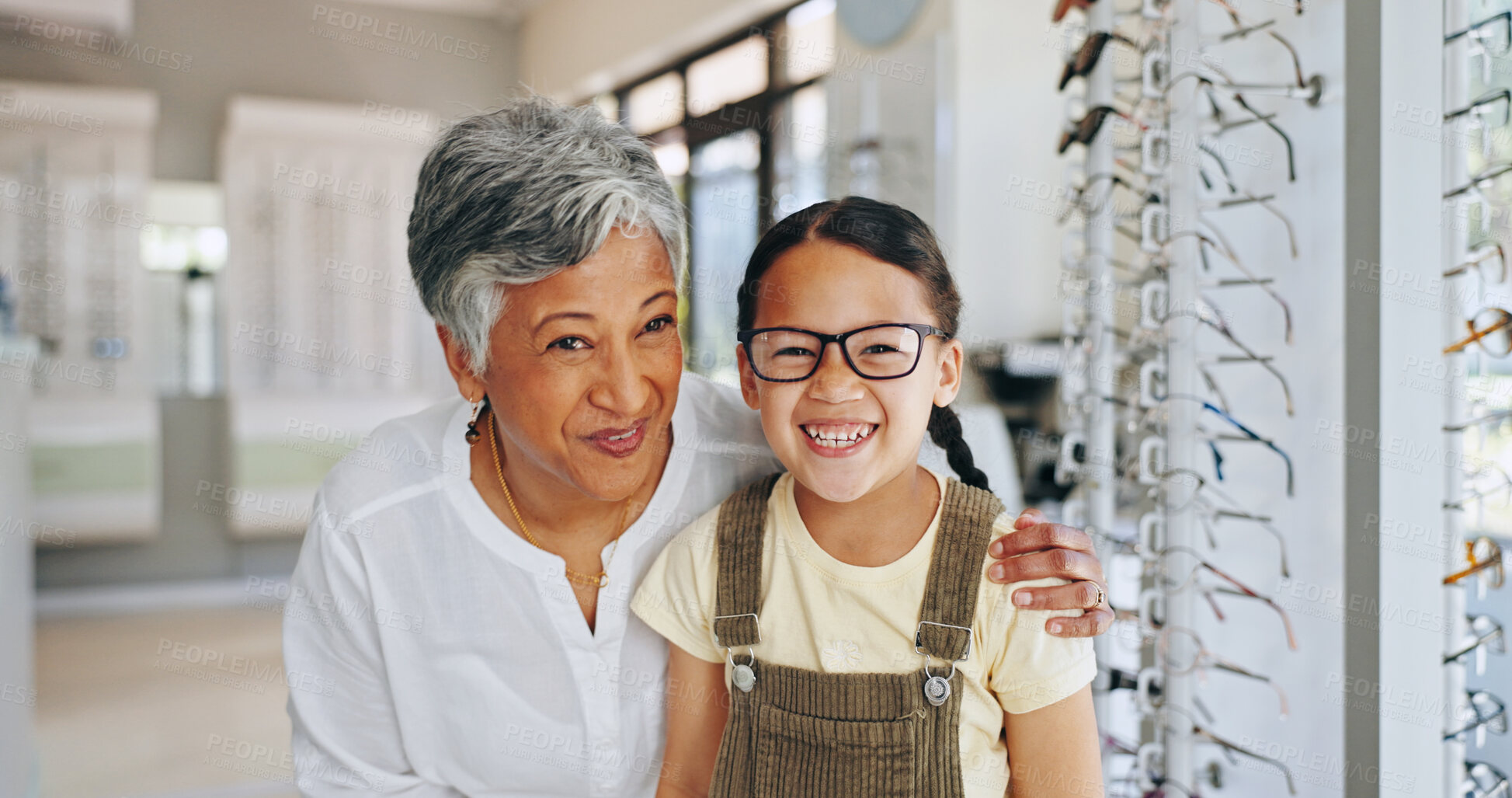 Buy stock photo Child portrait, optometrist and choice of frame at clinic, prescription glasses and helping client. Woman, optical store and specialist consulting on lens for girl, excited kid and care at eye exam