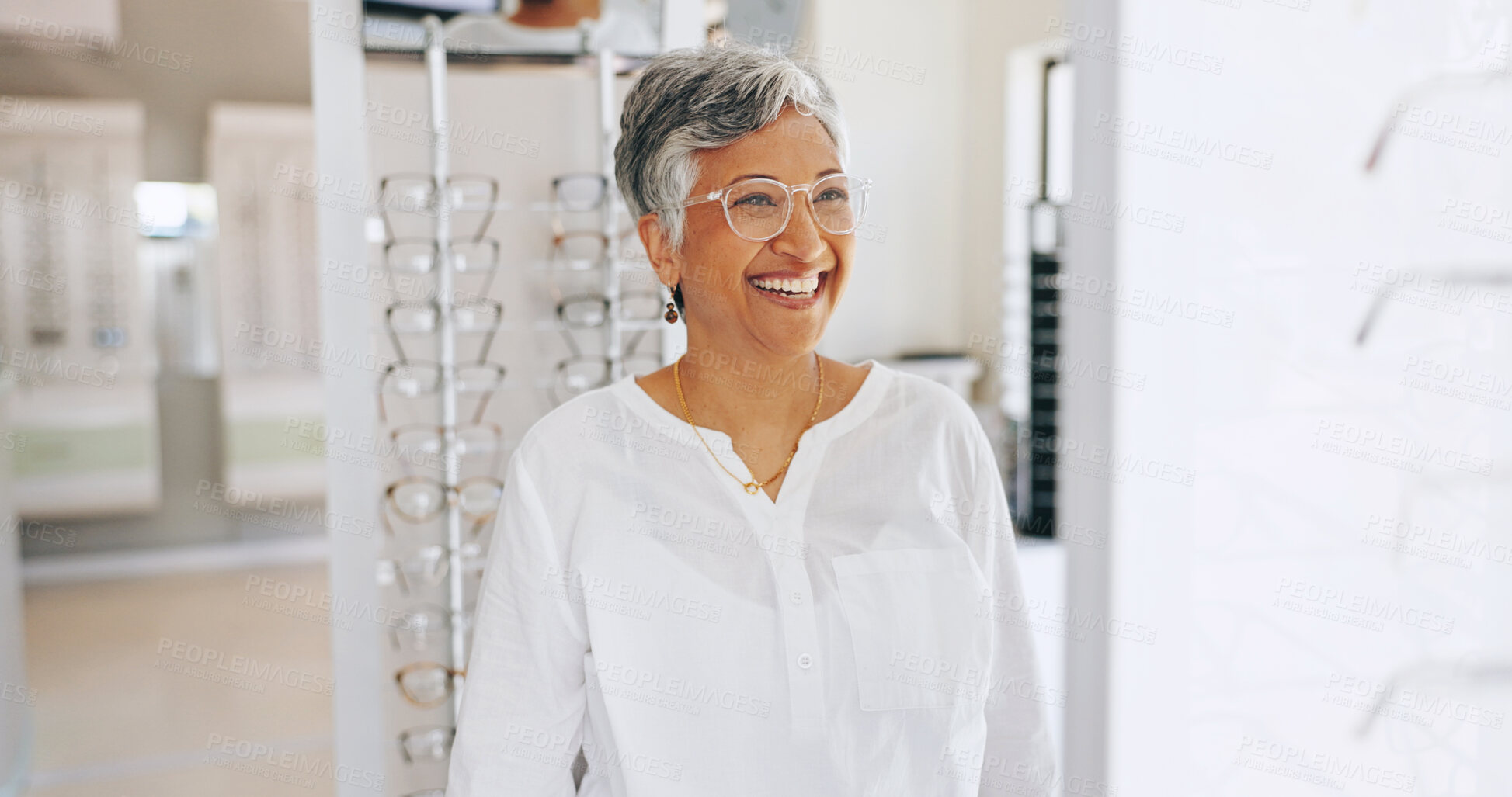 Buy stock photo Glasses, happy and mirror with mature woman in store for eye care, healthcare and optometry. Shopping, lens and frame choice with female customer in clinic for ophthalmologist, vision or prescription