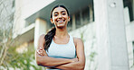 Portrait, training and woman in city, arms crossed and urban town with buildings, lens flare and exercise. Face, healthy athlete and person in street, smile and wellness with workout and sportswear