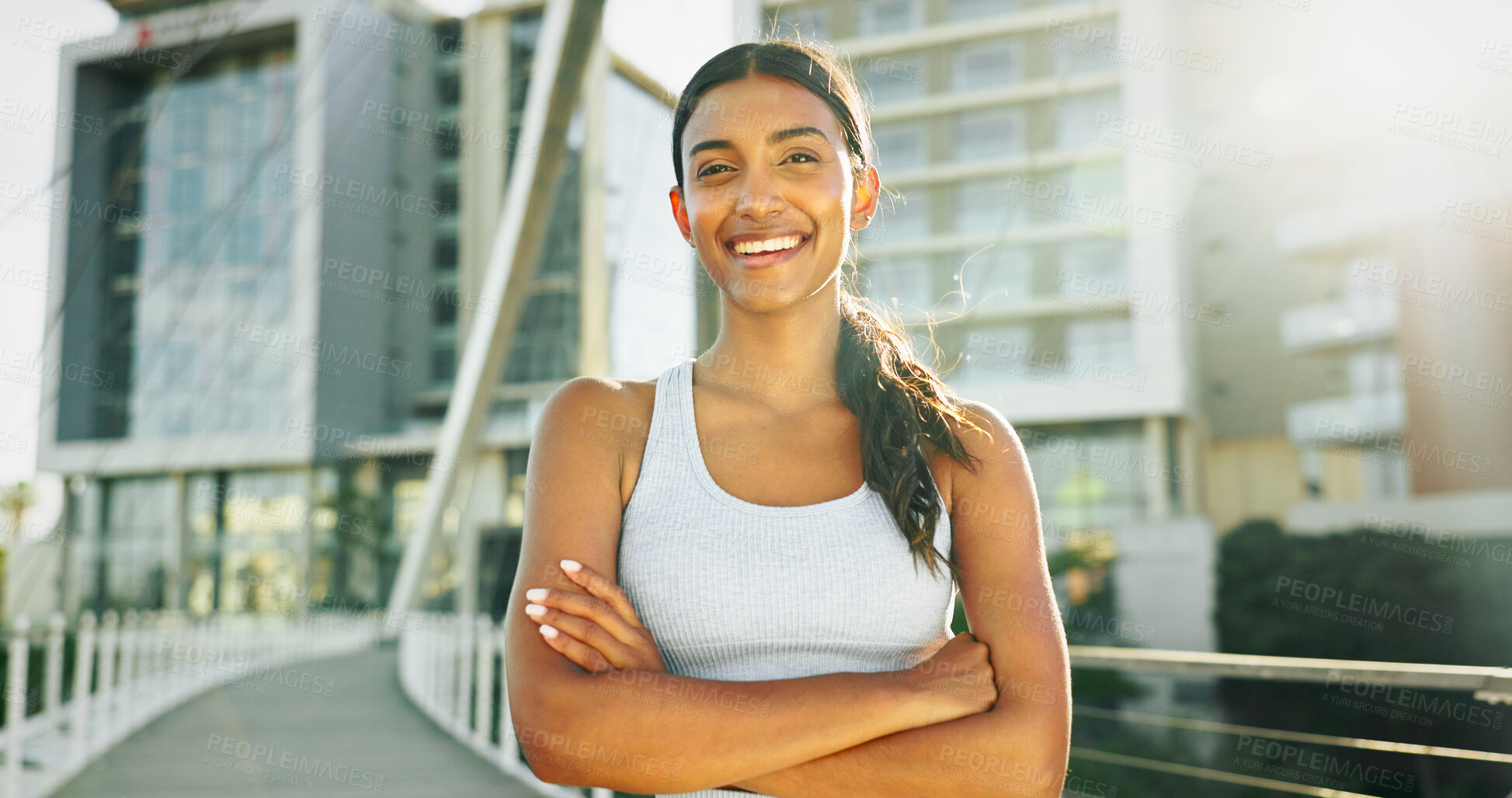 Buy stock photo Portrait, fitness and woman in city, arms crossed and urban town with buildings, lens flare and wellness. Face, healthy athlete and person in street, confidence and runner with workout and training