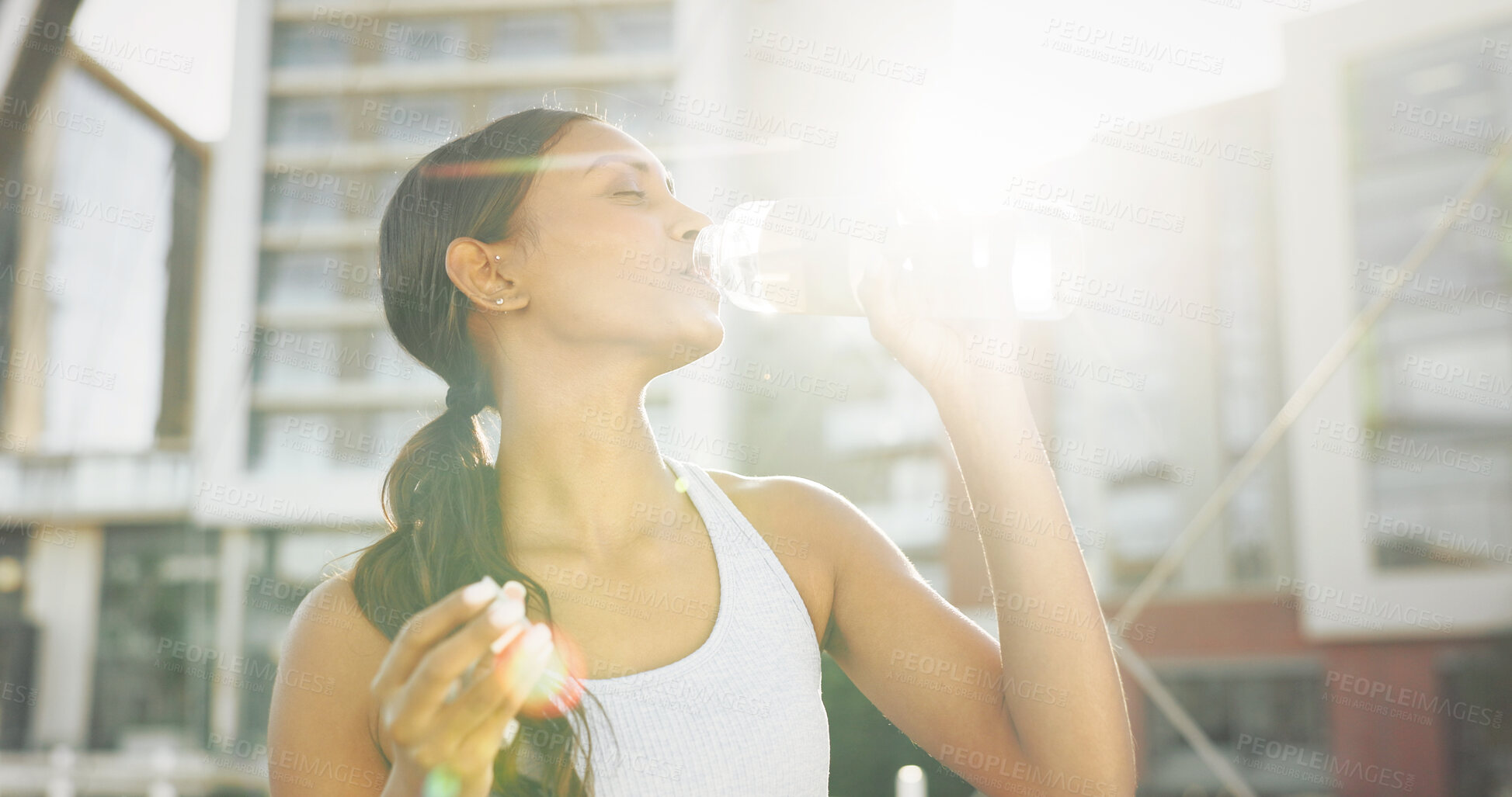 Buy stock photo Woman, drinking water and city athlete on break, liquid nutrition and sports drink for fitness. Female person, relax and bottle of h2o for refreshing rest in town, sun flare and exercise recovery