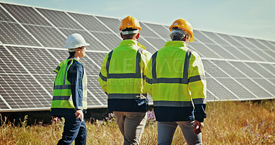 Buy stock photo Solar panel, walking and back with people, teamwork and cooperation for renewable energy project. Group, professional and employees in field, sustainability and inspection with quality control