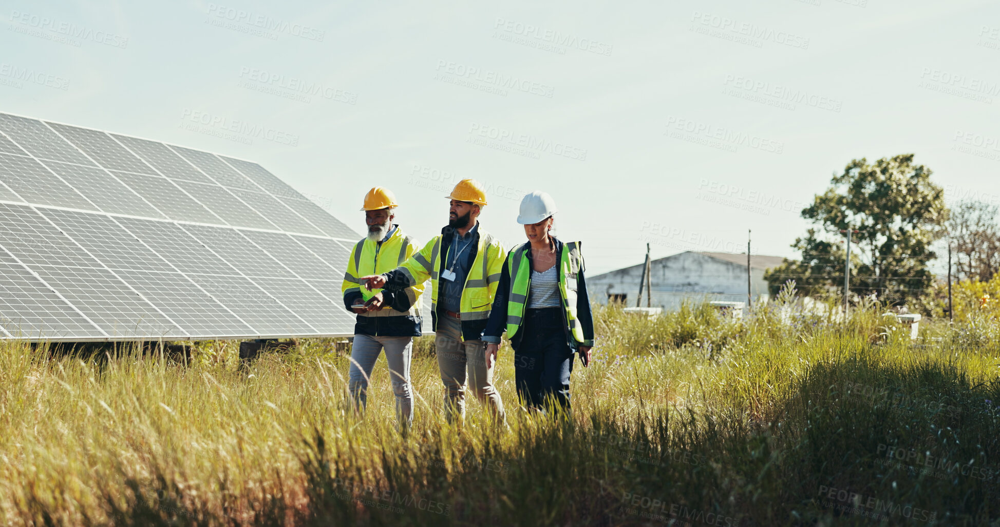 Buy stock photo People, technician and walking with team for solar panel installation, photovoltaic development or eco project in nature. Group, engineer or contractors with helmet for renewable energy or power