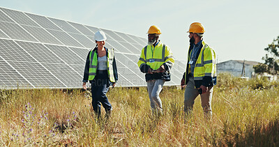 Buy stock photo Solar panels, team and walking with people in nature for photovoltaic grid, renewable energy or power generator. Sustainability, electric system or technician with engineer in outdoor for project