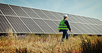 Solar panels, walk and grid with woman in nature for photovoltaic technician, renewable energy or power generator. Sustainability, electric system or inspection with engineer in outdoor for project
