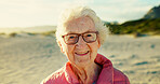Portrait, elderly woman and ocean for retirement or holiday with health, outdoor and wellness. Senior, female person and happiness as confident by beach for vacation, relax and adventure as pensioner