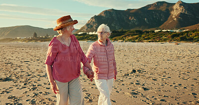 Buy stock photo Holding hands, smile and travel with old women at beach for summer vacation, retirement and happiness. Holiday, bonding and tourism with senior people for friends, adventure and care together