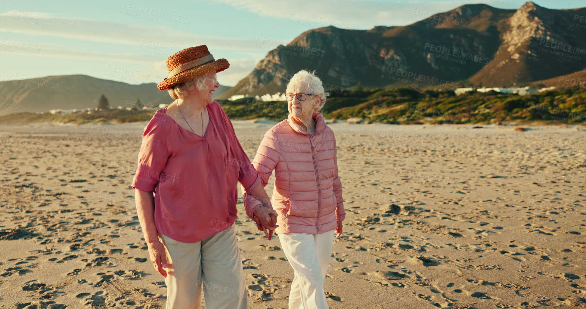 Buy stock photo Holding hands, smile and travel with old women at beach for summer vacation, retirement and happiness. Holiday, bonding and tourism with senior people for friends, adventure and care together