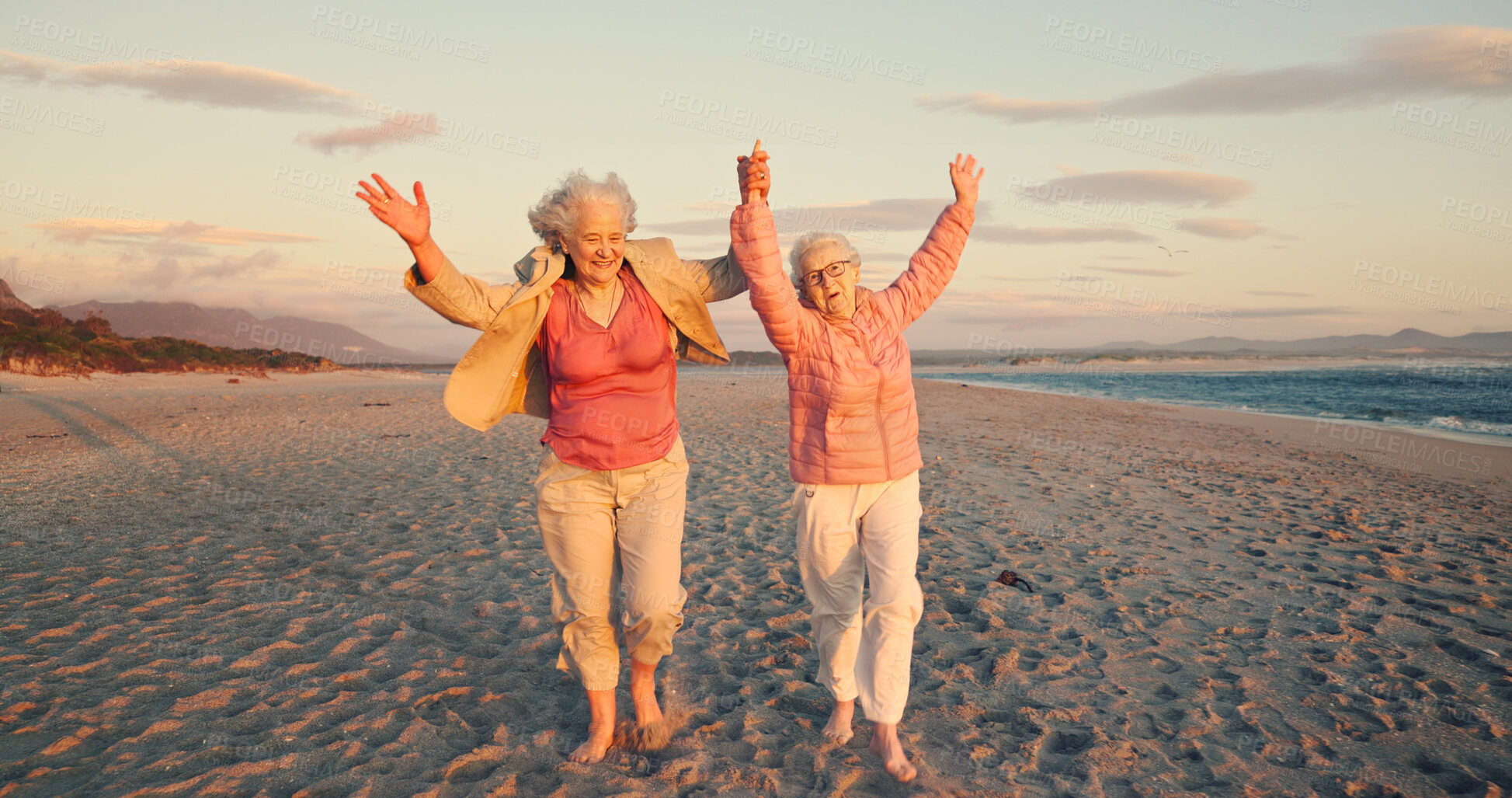 Buy stock photo Freedom, friends and happiness with old women at beach for bonding, retirement and holiday. Summer vacation, travel trip and adventure with senior people for holding hands, paradise and health