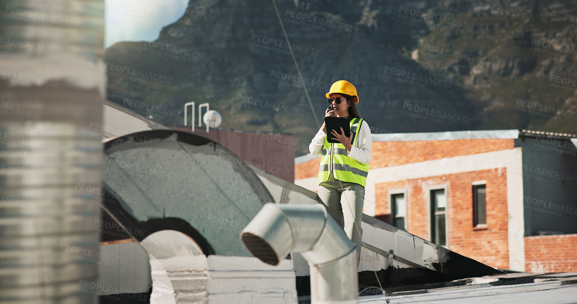 Buy stock photo Woman, radio and tablet for construction with air conditioning on roof, report and safety inspection in city. Person, technician or engineer with contact, talk and touchscreen for hvac in Colombia