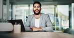 Portrait, laptop and happy business man in office for profit, budget or finance at enterprise. Face, smile and confident professional entrepreneur, expert employee and salesman working at desk in UAE