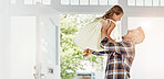 Father, laugh and lift child in home for reunion, welcome and family connection by door. Happy, girl and dad carry kid for support, bonding together or parent play funny game with daughter for return