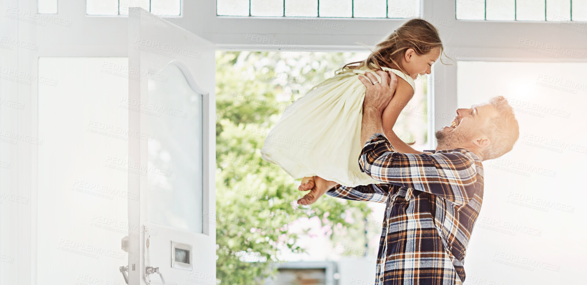 Buy stock photo Father, laugh and lift child in home for reunion, welcome and family connection by door. Happy, girl and dad carry kid for support, bonding together or parent play funny game with daughter for return