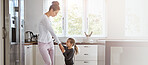 House, dancing and mother in kitchen, girl and bonding together with happiness. Parent, apartment and mama with daughter, kid and music with movement, energy and cheerful with break, funny and joyful