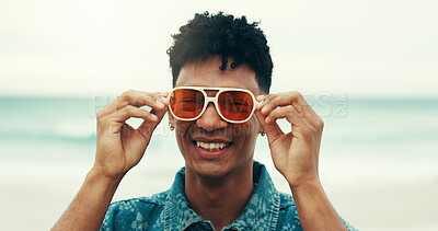 Buy stock photo Portrait, beach and guy with sunglasses, smile and fashion for holiday, adventure or summer vacation. Happy, travel and man with shades, ocean and confidence with weekend trip for Miami sea journey