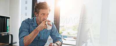 Buy stock photo Computer, coffee and reading with designer man at desk in office for development, planning or research. Banner, mockup and space with mature employee in workplace for online review of information