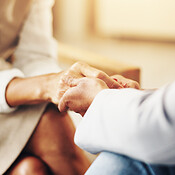 Psychologist, woman and holding hands for comfort, counseling and ...