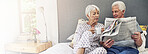 Bedroom, house and senior couple with newspaper, morning and reading with comfort. Pensioner, apartment and old man with elderly woman, conversation and relationship with information and marriage