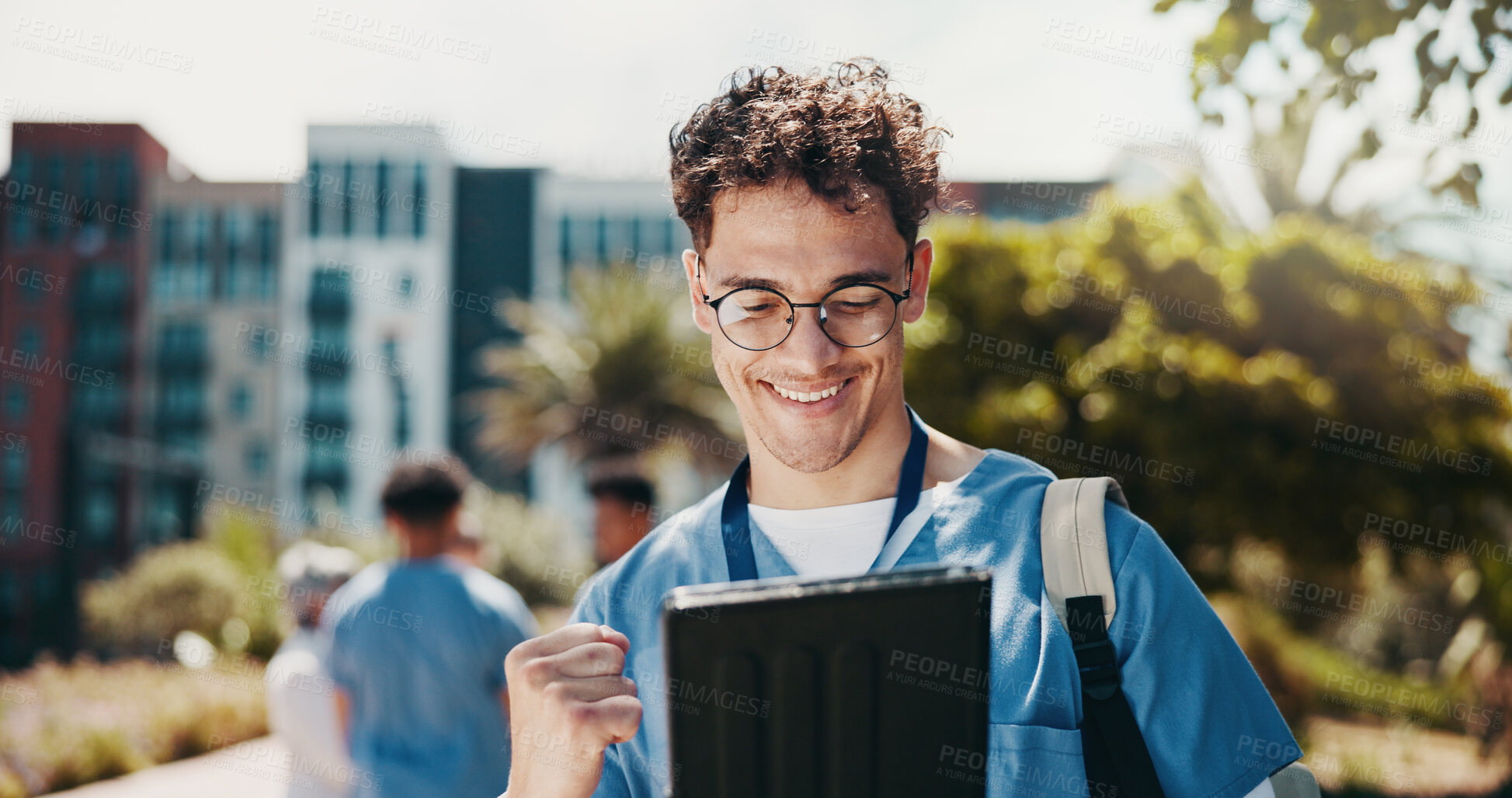 Buy stock photo Happy man, nurse or medical student with tablet for good news, winning or achievement at med school. Male person, healthcare intern or candidate with smile on technology for results or pass at campus