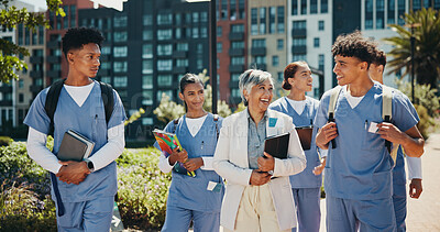 Buy stock photo Medical student, walking and professor with people in outdoor for college, healthcare and teacher. Scholarship, internship and doctors with students on hospital campus for assignment and education