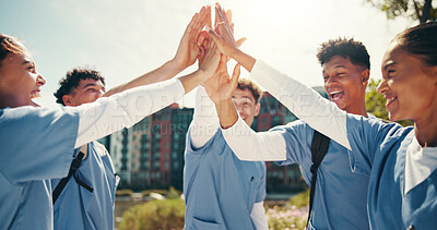 Buy stock photo Medical success, students and happy with hands together outdoor for training program support or board exam results. Diversity team, people and high five on campus for healthcare practice or education