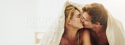 Buy stock photo Kiss, happy and couple on bed in morning for relax, loving relationship and bonding with blanket. Dating, mockup space and banner of man and woman with embrace for romance, affection and love in home