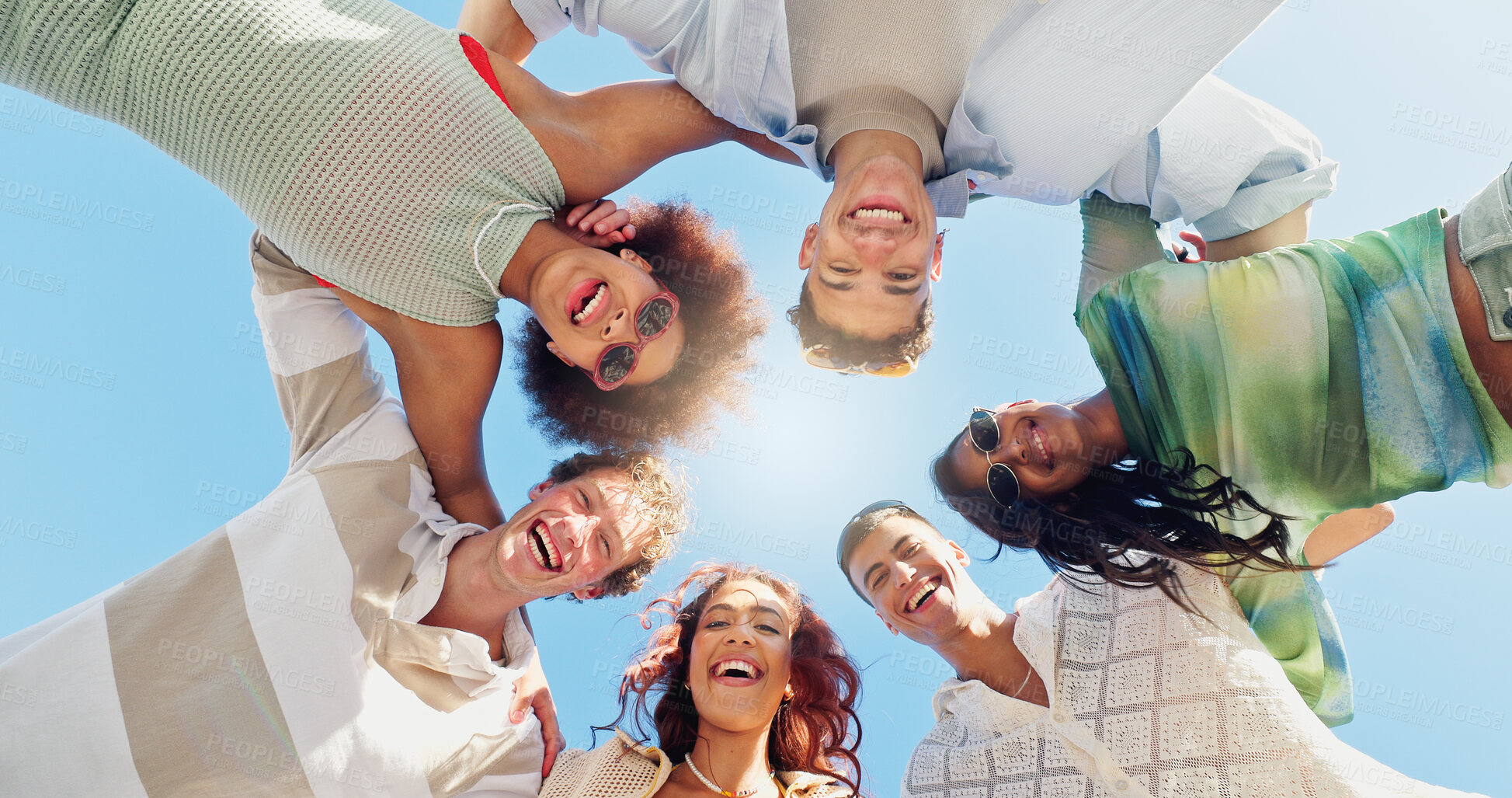 Buy stock photo Happy people, portrait and below with circle in huddle for inclusion, bonding or summer together in blue sky. Low angle, group or friends with smile or team in unity for community, holiday or weekend