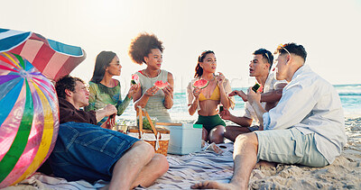 Buy stock photo People, friends and watermelon at beach, picnic and conversation with eating, vacation and reunion. Group, women and men with fruit, happy and outdoor together with diversity by ocean in sunshine