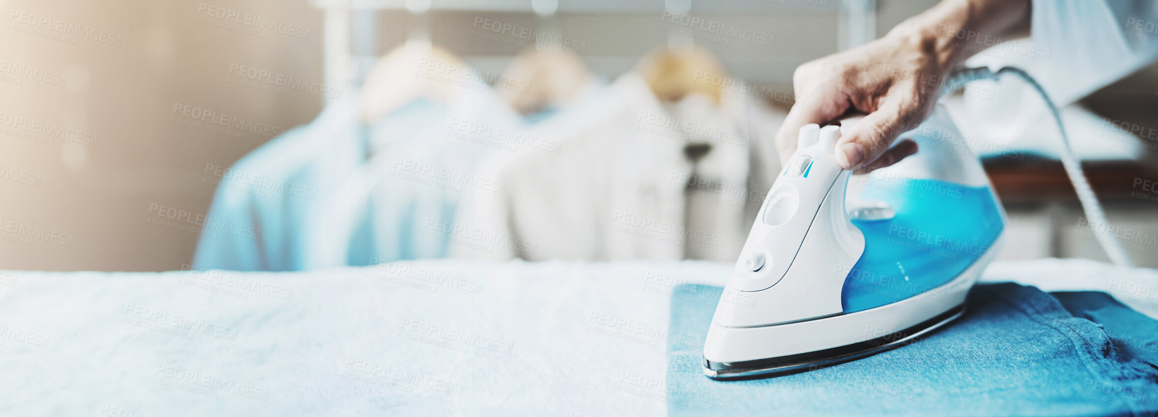 Buy stock photo Hands, person and ironing jeans in home for chores, cleaning and laundry on banner space. Closeup, electric appliance and steam on board for clothes, housework and housekeeping for hygiene on fabric