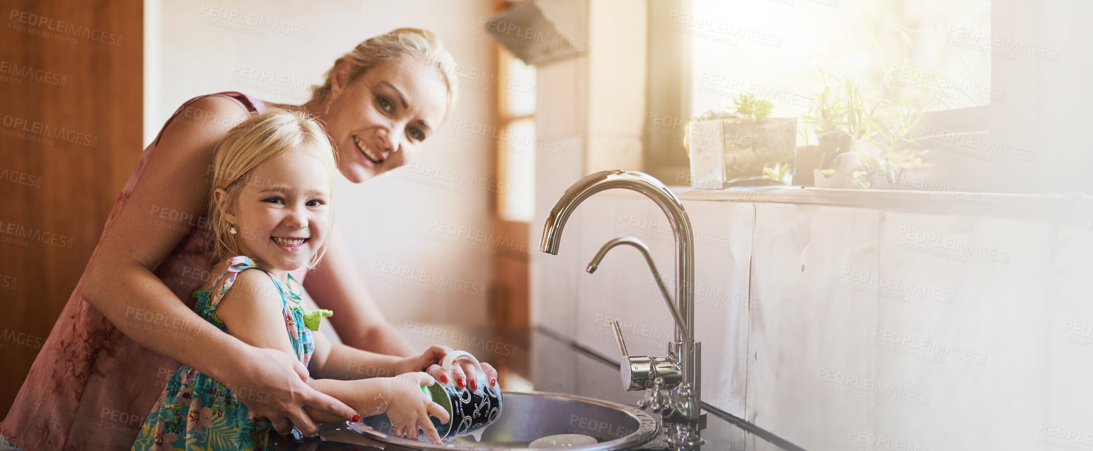 Buy stock photo Kitchen, mother and happy with girl washing dishes on portrait for bonding and support at home. Apartment, banner and parent with kid for hygiene with teaching or help for child development
