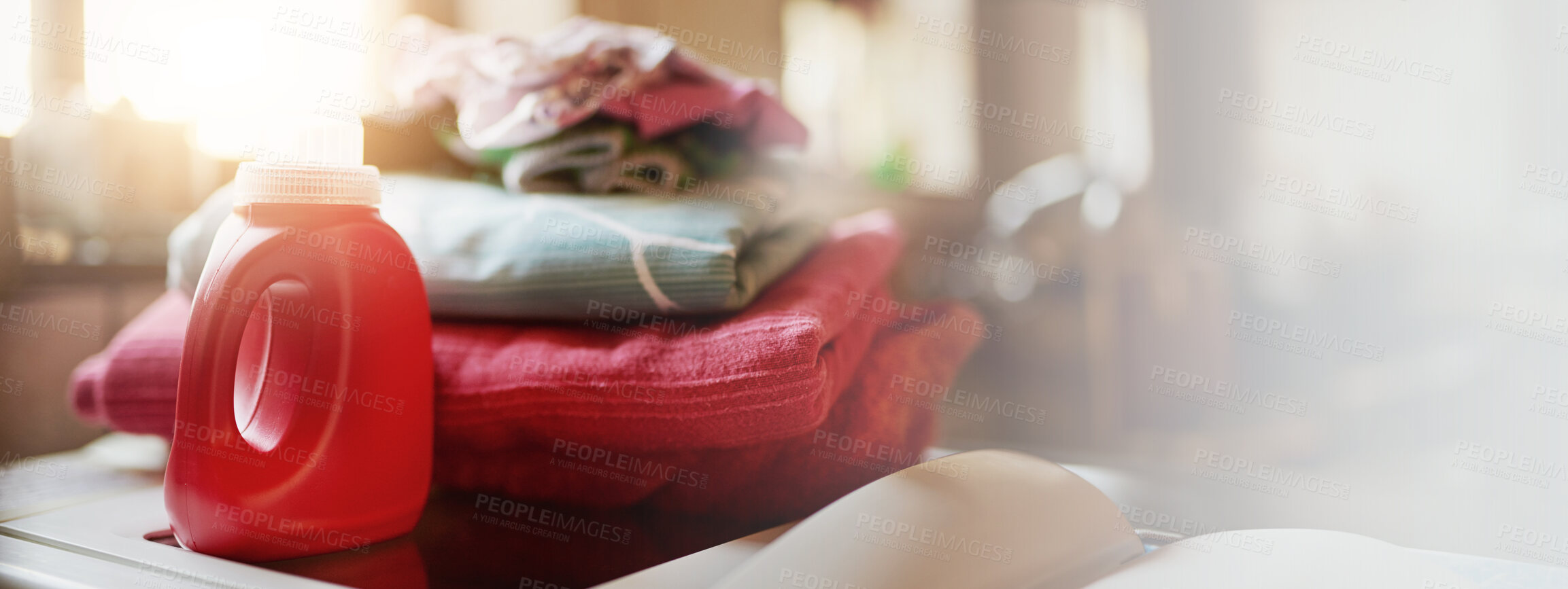 Buy stock photo Laundry, detergent bottle and clean clothes at house for fresh smell, hygiene and maintenance product. Banner, liquid and linen stack with housework, hospitality service and softener and housekeeping