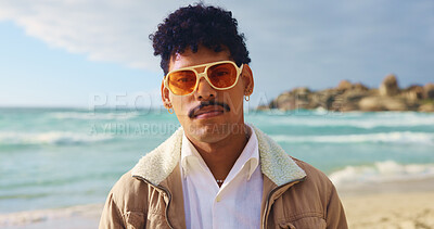Buy stock photo Portrait, man and sunglasses on beach outdoor for summer vacation, travel destination and nature tourism. Male person, fashion and streetwear for holiday break, tropical adventure and Florida getaway