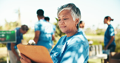 Buy stock photo Charity, checklist and clipboard with woman volunteer outdoor in park for community food drive or donation. Activism, documents and manifest with mature person as welfare worker for NGO or non profit