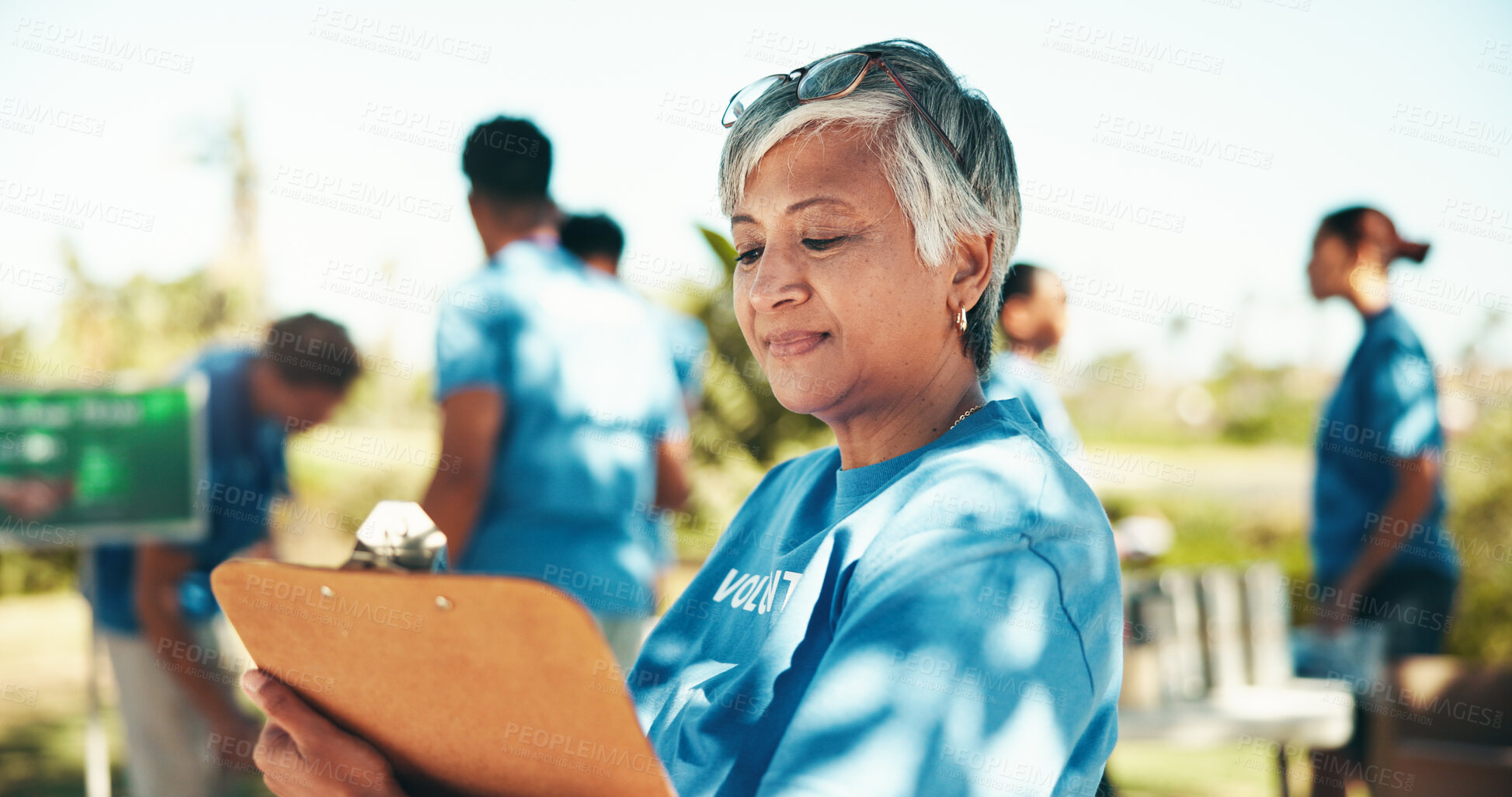 Buy stock photo Charity, checklist and clipboard with woman volunteer outdoor in park for community food drive or donation. Activism, documents and manifest with mature person as welfare worker for NGO or non profit