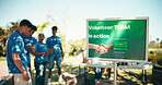 Volunteer, team and billboard with poster for community service, charity or non profit organization at park. People, group or advertising with donations for poor society, humanity or food supplies