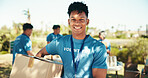 Man, smile and portrait of volunteer in nature with community service, NGO or donation project. Happy, confident and face of male charity worker with confidence outdoor in field for social activism.