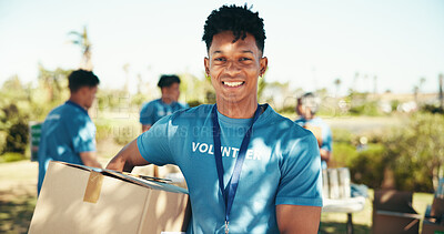 Buy stock photo Man, smile and portrait of volunteer in nature with community service, NGO or donation project. Happy, confident and face of male charity worker with box outdoor in field for social activism.