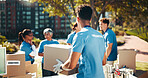Box, volunteer team and outdoor for donation, help and back for community care. NGO group, man and charity service with package for distribution, food drive and humanitarian aid with poverty supplies