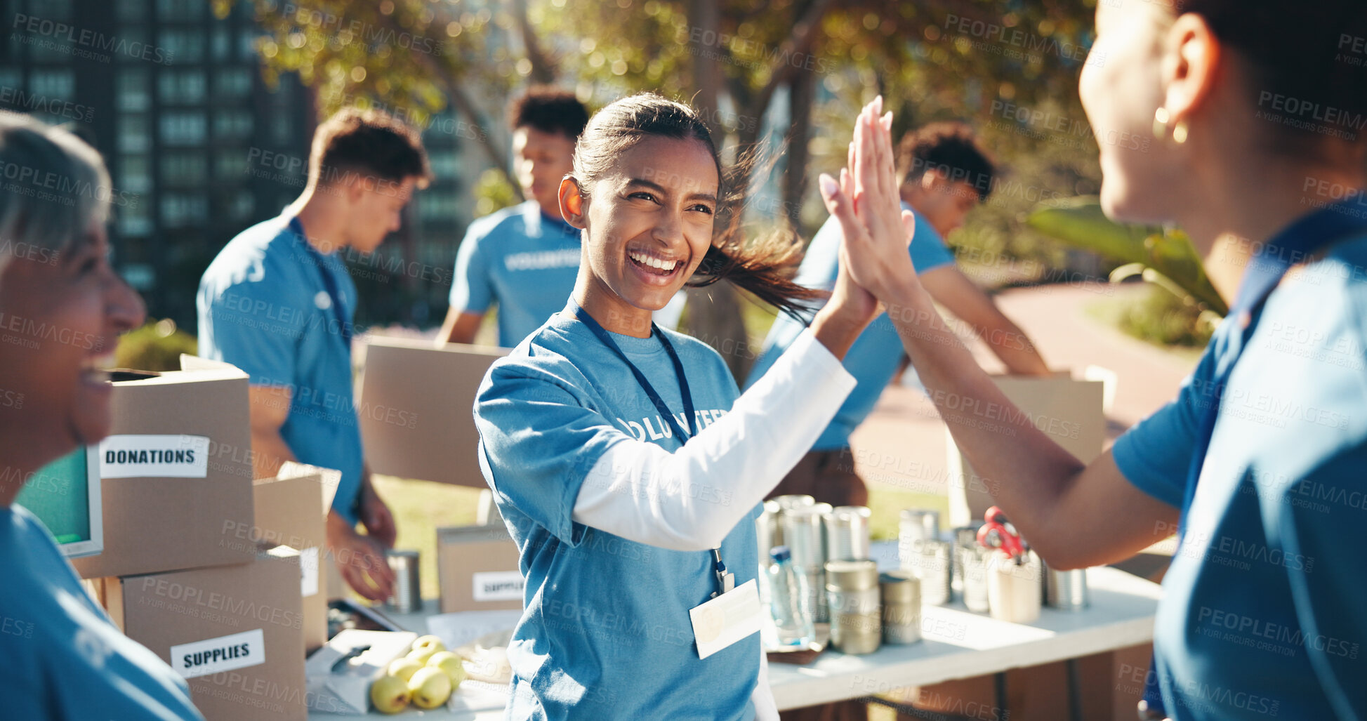 Buy stock photo Outdoor, volunteer and group with high five, community service and goals for donations, charity and support. NGO project, people and friends in park, teamwork and hand gesture with problem solving