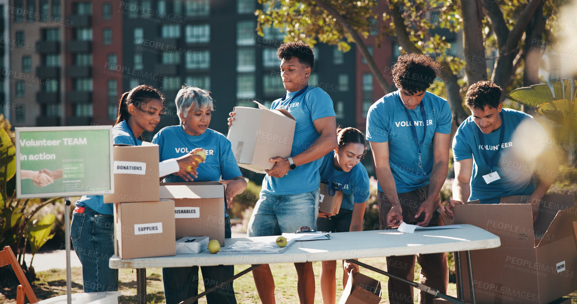 Buy stock photo Outdoor, food drive and group of volunteers with help, goals and donations at charity event in park. Non profit, happy and NGO people in field in nature for community service project in collaboration