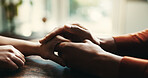 Couple, holding hands and consoling on table at house of compassion, partnership and sympathy of depression. People, support and comfort of relationship crisis, partner empathy and loyalty connection