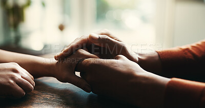 Buy stock photo Couple, holding hands and consoling on table at house of compassion, partnership and sympathy of depression. People, support and comfort of relationship crisis, partner empathy and loyalty connection