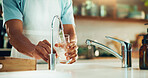 Person, kitchen and hands with glass of water in tap for fresh drink, liquid and hydration. Sink closeup, thirsty or pouring pure beverage in container for nutrition, drinking or filtration in home