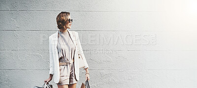 Buy stock photo Woman, shopping bag and travel for fashion in city, wall and mockup space for discount in street. Person, baggage and thinking with style, sale and retail deal with waiting for taxi on road in France