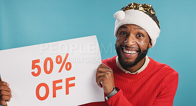 Buy stock photo Discount poster, happy and portrait of black man in studio with advertisement for promotion. Excited, board and African male person with sign for deal with christmas shopping by blue background.