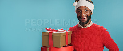 Buy stock photo Portrait, black man and boxes on Christmas in studio of festive celebration, surprise present and Santa Claus. Smile, male person and special gift of giving season, holiday reward and blue background